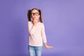 Photo of guilty pretty lovely small girl wear glasses cover hand mouth sorry isolated on violet color background