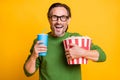 Photo of guy hold bucket popcorn plastic cup soda open mouth wear specs green pullover isolated yellow color background