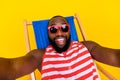 Photo guy tourist relax chaise longe deckchair make selfie wear swim suit red set isolated vibrant color background Royalty Free Stock Photo