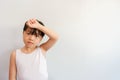 A photo of a half-up girl raising her hand during a morning exercise pose with a bright face. Royalty Free Stock Photo