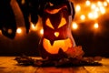 Photo of halloween pumpkin cut in shape of face with witch`s hand Royalty Free Stock Photo