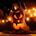 Photo of halloween pumpkin cut in shape of face with witch`s hand Royalty Free Stock Photo