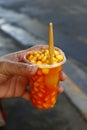 Freshly cooked corn with cheese flavor in a plastic glass