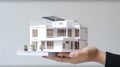 photo hand presenting model house for home loan campaign