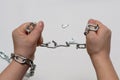 Photo of hands holding a broken chain