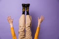 Photo of hands and legs wearing velvet pants and black shoes