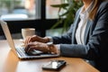 Photo of hands typing on a laptop. inside an office, business oriented atmosphere. Generative AI