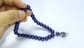 Photo of hands using prayer beads isolated on white background Royalty Free Stock Photo