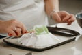 ÃÂ photo of hands of a woman who is creating with a scapula a form of a meringue