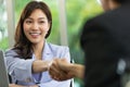 Photo of handshaking in a personnel office after job interview with soft focus on Asian young applicant woman. Concept of career Royalty Free Stock Photo