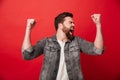 Photo of handsome cheerful man 30s in jeans jacket screaming and Royalty Free Stock Photo