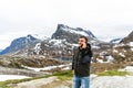 Handsome happy young man outside in free alternative vacation camping talking by mobile phone Royalty Free Stock Photo