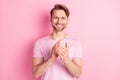 Photo of handsome sweet young gentleman dressed casual t-shirt applauding hands arms palms smiling pink color