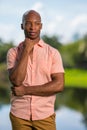 Photo handsome young black man smiling and looking of camera. Hand posed under his chin in an outdoor setting Royalty Free Stock Photo