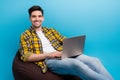 Photo of handsome young guy it specialist working remote programming his own website for junior coders isolated on blue
