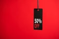 Photo of hanging black price tag on isolated red background with text 50% off Royalty Free Stock Photo