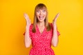 Photo of happy amazed astonished young woman win raise hands isolated on shine yellow color background