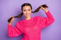 Photo of happy attractive young woman hold hair braids tails smile isolated on violet color background Royalty Free Stock Photo