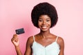 Photo of happy brown haired young woman hold credit card beaming smile isolated on pink color background Royalty Free Stock Photo