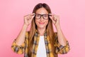 Photo of happy charming mature woman wear glasses oculist vision face hands on pink color background