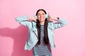 Photo of happy charming young woman music lover dance good mood isolated on pastel pink color background Royalty Free Stock Photo