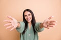 Photo of happy charming young woman open hands you welcome nice smile isolated on pastel beige color background Royalty Free Stock Photo