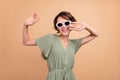 Photo of happy charming young woman weekend free time dance good mood isolated on beige color background Royalty Free Stock Photo
