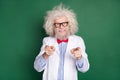 Photo of happy cheerful good mood funky mad scientist with messy hair point finger you isolated on green color