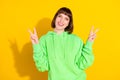 Photo of happy cheerful nice young woman make v-signs smile good mood isolated on yellow color background Royalty Free Stock Photo