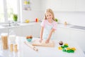 Photo of happy cheerful young girl knead dough bake cookie smile enjoy indoors inside house home kitchen