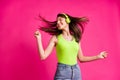 Photo of happy cheerful young girl listen music headphones dance enjoy happy fun isolated over pink color background Royalty Free Stock Photo