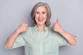 Photo of happy excited cheerful good mood mature woman showing thumb-up approval isolated on grey color background Royalty Free Stock Photo