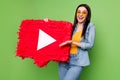 Photo of happy excited crazy charming woman in sunglass show big red play button isolated on green color background Royalty Free Stock Photo