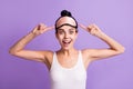 Photo of happy excited smiling lovey girl point finger at eye mask wake up morning isolated on purple color background Royalty Free Stock Photo