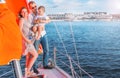 A happy family. Husband, pregnant wife and son on the yacht