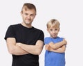 Portrait of happy father and son in casuals with arms crossed over white background Royalty Free Stock Photo