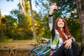 Photo of happy girl photographing herself in autumn forest Royalty Free Stock Photo