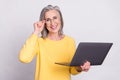 Photo of happy good mood beautiful mature businesswoman in glasses working in laptop isolated on grey color background Royalty Free Stock Photo