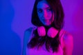 Photo of happy good mood beautiful stunning girl with headphones long brown hair on neon glowing background