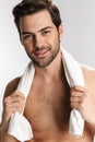 Photo of happy half-naked man posing with towel and smiling Royalty Free Stock Photo