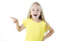 Photo of happy little girl standing. Looking camera showing copyspace pointing. Royalty Free Stock Photo