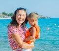 Photo of happy mother and son on the beach