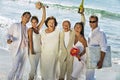 Portrait of happy newlywed couples with family celebrating on beach Royalty Free Stock Photo