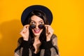 Photo of happy nice cunning woman look empty space take off glasses on shine yellow color background