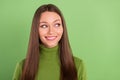 Photo of happy nice dreamy cheerful woman look empty space smile face isolated on green color background