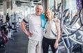 Happy older married couple in the gym. Hugs and looks at the camera Royalty Free Stock Photo