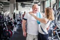 Happy older married couple in the gym. Hugs and looks at the camera Royalty Free Stock Photo