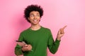 Photo of happy positive guy hold tablet demonstrate finger empty space adverts isolated pastel color background