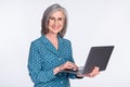 Photo of happy positive smiling beautiful businesswoman working in laptop typing isolated on grey color background Royalty Free Stock Photo