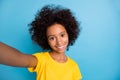 Photo of happy pretty afro american girl make selfie nice smile  on pastel blue color background Royalty Free Stock Photo